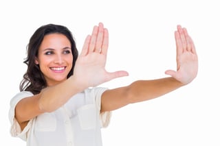 Pretty brunette holding up hands on white background.jpeg